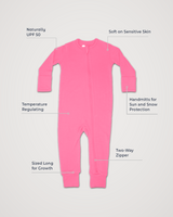 Merino Wool Adventure Zippy romper in bright pink, laid flat with feature callouts: naturally UPF 50, soft on sensitive skin, temperature regulating, handmitts for sun and snow protection, two-way zipper, sized long for growth #color_alpenglow