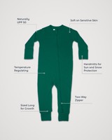 Merino Wool Adventure Zippy romper in evergreen green, laid flat with feature callouts: naturally UPF 50, soft on sensitive skin, temperature regulating, handmitts for sun and snow protection, two-way zipper, sized long for growth #color_evergreen