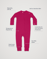 Merino Wool Adventure Zippy romper in deep pink, laid flat with feature callouts: naturally UPF 50, soft on sensitive skin, temperature regulating, handmitts for sun and snow protection, two-way zipper, sized long for growth #color_peak pink