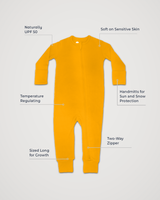 Merino Wool Adventure Zippy romper in golden yellow, laid flat with feature callouts: naturally UPF 50, soft on sensitive skin, temperature regulating, handmitts for sun and snow protection, two-way zipper, sized long for growth #color_yellowstone