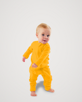 Toddler walking barefoot while wearing a golden yellow Merino Wool Adventure Zippy romper with front zipper #color_yellowstone