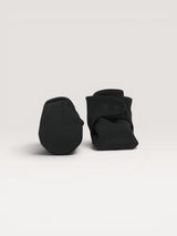 Iksplor black merino wool baby booties with a secure snap closure on a neutral background. #color_teton eclipse