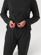 Iksplor black merino wool adventure joggers with a high rise waist and drawstring, worn by a person in a studio. #color_teton eclipse