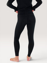 Iksplor black merino wool baselayer leggings worn by a person, back view showing a slim, non-bunching fit. #color_teton eclipse - black