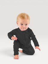 Iksplor infant wearing a black merino wool zip romper with long sleeves and snug cuffs on a light grey background #color_teton eclipse