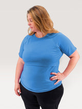 Woman wearing a blue Iksplor merino wool short-sleeve nursing t-shirt with discreet access for breastfeeding. #color_blue sky