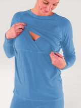 Iksplor blue merino wool long sleeve nursing top with discreet chest access and thumb holes on a woman. #color_blue sky