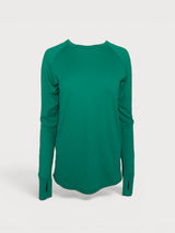 Iksplor emerald green merino wool long sleeve top with thumbhole cuffs and a curved hemline. #color_evergreen