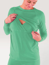 Iksplor green merino wool long sleeve nursing top with discreet chest access and thumb holes on a woman. #color_meadow