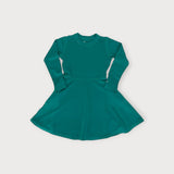 Iksplor kids long-sleeve merino wool adventure dress in deep green with a flared skirt and pockets. #color_evergreen