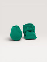 Iksplor emerald green baby merino wool booties with secure snap closures on a neutral background. #color_evergreen