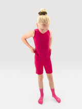 Iksplor kids merino wool tank top and matching shorts in vibrant pink, worn by a young girl with a hair bun. #color_peak pink