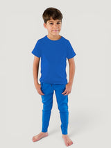 Boy wearing a blue Iksplor merino wool t-shirt and matching joggers for active outdoor play. #color_ocean