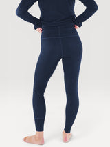 Iksplor navy blue merino wool baselayer leggings worn by a person, back view showing a slim, comfortable fit. #color_starry night - navy