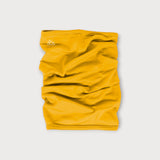 Iksplor mustard yellow merino wool neck gaiter with a small white mountain logo on a light grey background. #color_yellowstone