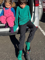 Iksplor natural fiber trail socks in green and purple worn by children sitting on the back of a car  #color_purple reign