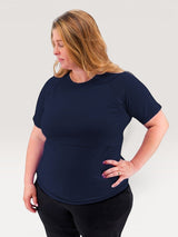 Woman wearing a navy blue Iksplor merino wool short sleeve nursing t-shirt with discreet access for breastfeeding. #color_starry night