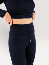 Iksplor navy blue merino wool midweight leggings with a high-waisted drawstring waistband on a person.