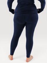 Iksplor navy blue merino wool baselayer leggings worn from the back, featuring a slim fit for layering. #color_starry night - navy