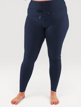 Iksplor navy blue merino wool baselayer leggings with a high-rise drawstring waistband on a model. #color_starry night - navy