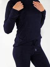 Iksplor navy blue merino wool long sleeve top worn by a model, featuring a soft, temperature-regulating design.  #color_starry night