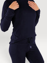 Iksplor navy blue merino wool long sleeve top worn by a model, featuring a soft, temperature-regulating design.  #color_starry night