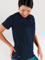 Woman wearing a navy blue Iksplor merino wool t-shirt with UPF 50 protection and a soft, breathable fit. #color_starry night