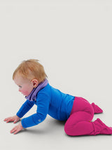 Iksplor baby merino wool leggings in bright pink with a comfortable wide waistband on a crawling toddler #color_peak pink