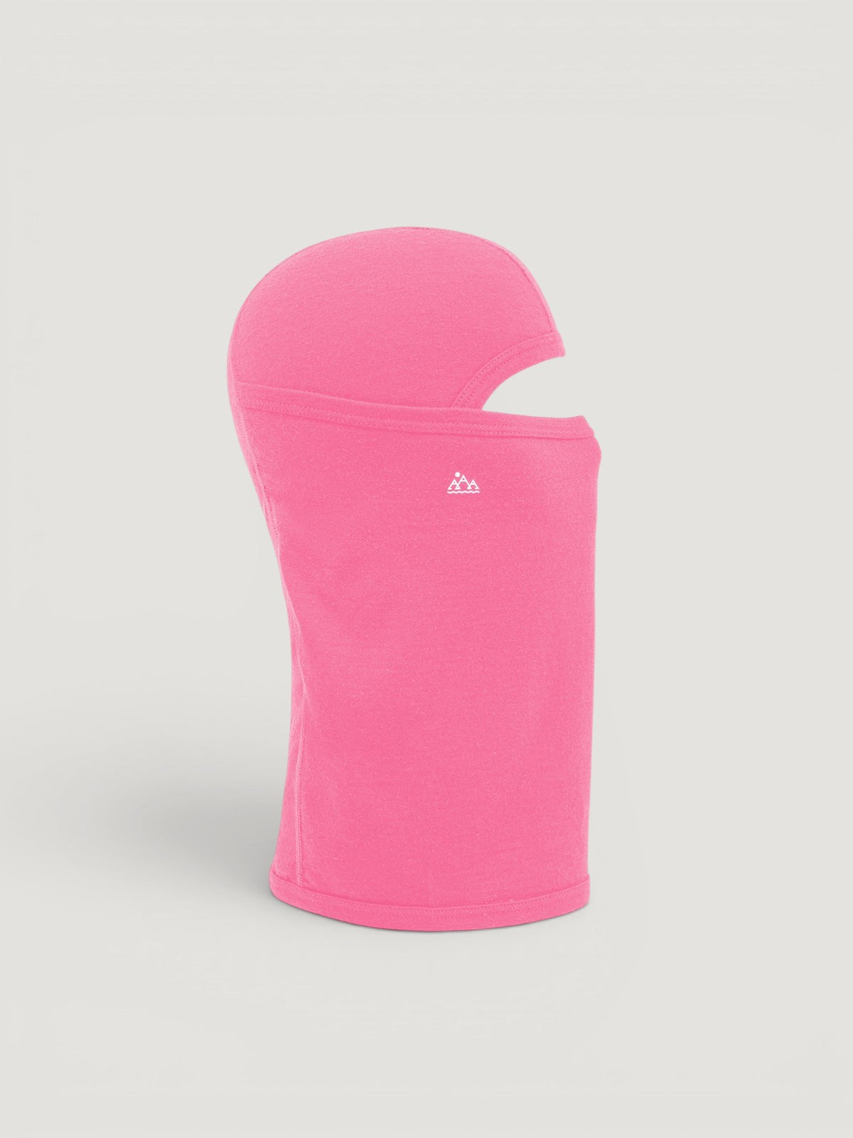 Iksplor pink merino wool balaclava featuring a ponytail hole and small mountain logo, side view #color_alpenglow