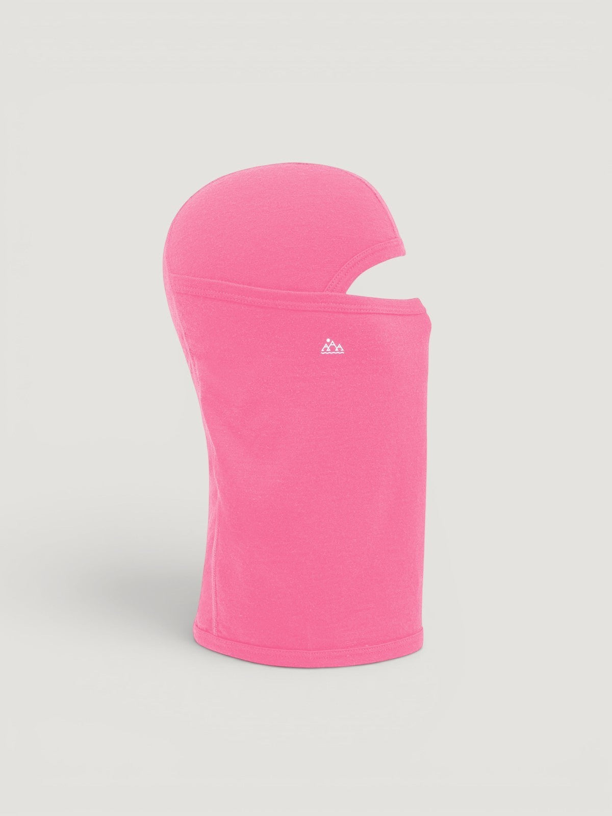 Iksplor pink merino wool balaclava featuring a ponytail hole and small mountain logo, side view #color_alpenglow
