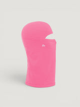 Iksplor pink merino wool balaclava featuring a ponytail hole and small mountain logo, side view #color_alpenglow