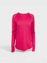 Iksplor bright pink merino wool long sleeve top with thumbhole cuffs and raglan sleeves on a light grey background. #color_peak pink