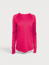 Iksplor bright pink merino wool long sleeve top with thumbhole cuffs and raglan sleeves on a light grey background. #color_peak pink