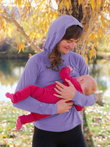 Iksplor purple merino wool nursing sun hoodie worn by a mother breastfeeding her baby outdoors in autumn. #color_lilac