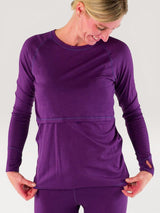 Iksplor purple merino wool long sleeve nursing top with thumb holes on a woman looking down #color_huck-it-berry