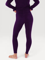 Iksplor deep purple merino wool baselayer leggings worn from the back, showing a slim, comfortable fit. #color_huck-it-berry