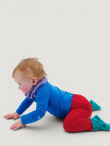 Iksplor baby wearing red merino wool leggings with a wide waistband while crawling on a light background. #color_campfire