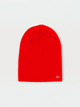 Iksplor bright red merino wool beanie for kids with a small mountain logo on a light background #color_wild flame