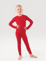 A young girl wearing a bright red Iksplor merino wool long-sleeve base layer top and matching leggings. #color_campfire