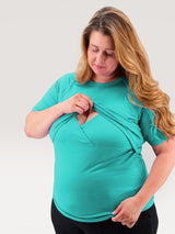 Iksplor teal merino wool short sleeve nursing t-shirt with discreet wrap-front access worn by a woman. #color_tidepool